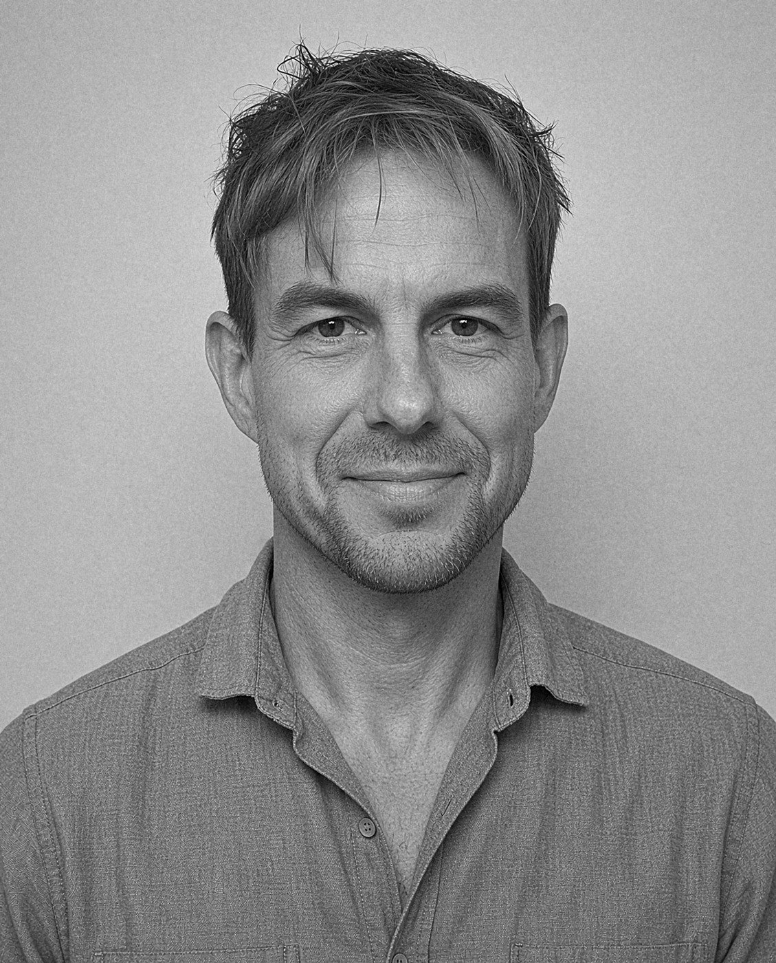 Black and white portrait of Scott Picard in a collared shirt against a plain background